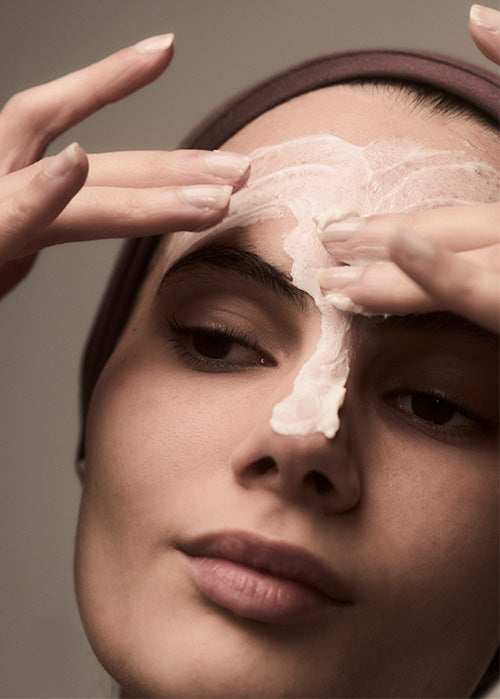 Woman applying Radiant Solice an her face